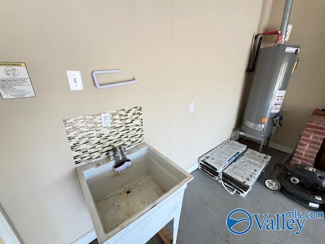 15031 Ashmont Blvd SE, Huntsville, AL 35803 - room details featuring concrete flooring, water heater, and a sink