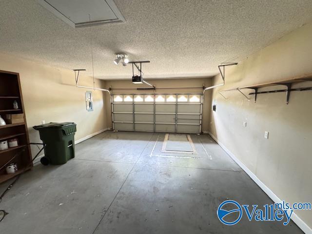 15031 Ashmont Blvd SE, Huntsville, AL 35803 - garage featuring baseboards and a garage door opener