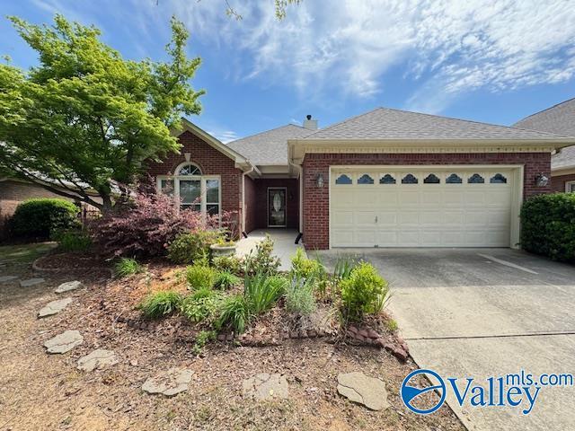 15031 Ashmont Blvd SE, Huntsville, AL 35803 - single story home featuring an attached garage, brick siding, roof with shingles, and concrete driveway