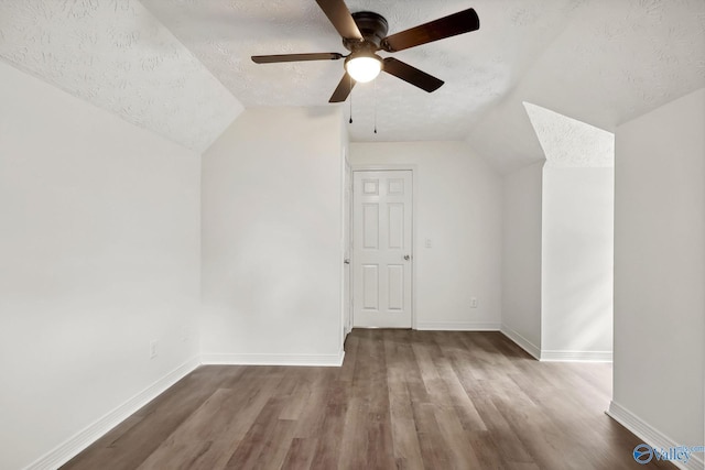 1502 Bower Dr SE, Cullman, AL 35055 - additional living space featuring vaulted ceiling, a ceiling fan, wood finished floors, a textured ceiling, and baseboards
