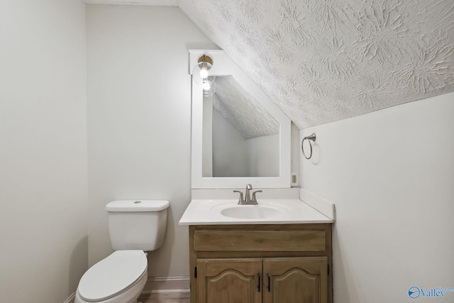 1502 Bower Dr SE, Cullman, AL 35055 - half bathroom with toilet, vanity, a textured ceiling, lofted ceiling, and baseboards