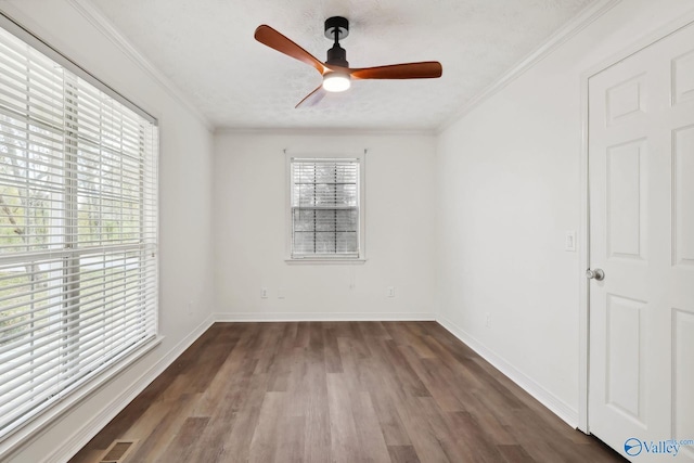 1502 Bower Dr SE, Cullman, AL 35055 - unfurnished room featuring a ceiling fan, dark wood-style floors, crown molding, and visible vents