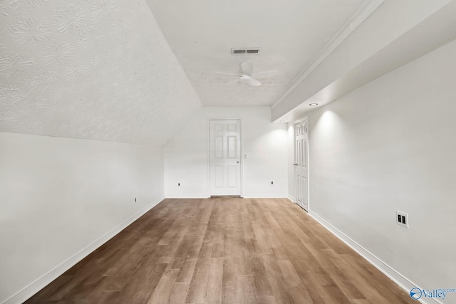 1502 Bower Dr SE, Cullman, AL 35055 - additional living space with a ceiling fan, wood finished floors, a textured ceiling, baseboards, and visible vents