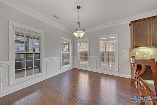 dining area featuring ornamental molding, dark wood-type flooring, and visible vents