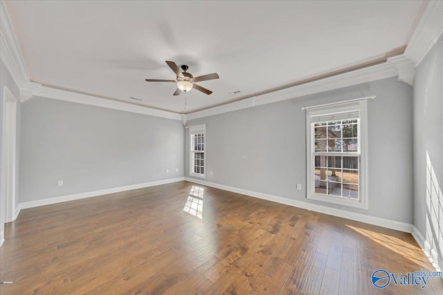 spare room featuring crown molding, ceiling fan, baseboards, and wood finished floors