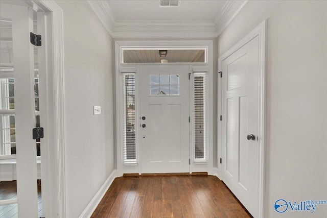 foyer with ornamental molding, dark wood-style flooring, visible vents, and baseboards