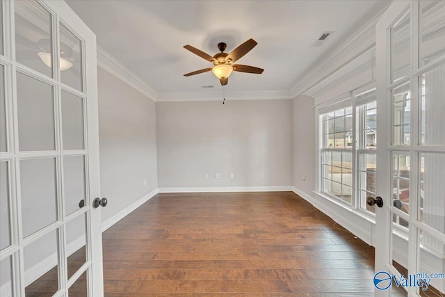 empty room with dark wood-style floors, french doors, baseboards, and crown molding