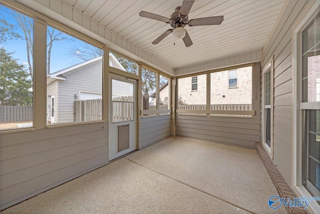 unfurnished sunroom with a healthy amount of sunlight and a ceiling fan