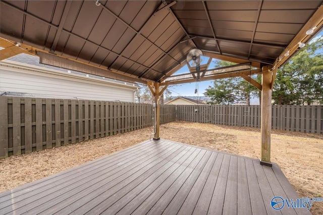 wooden deck with a fenced backyard and a gazebo