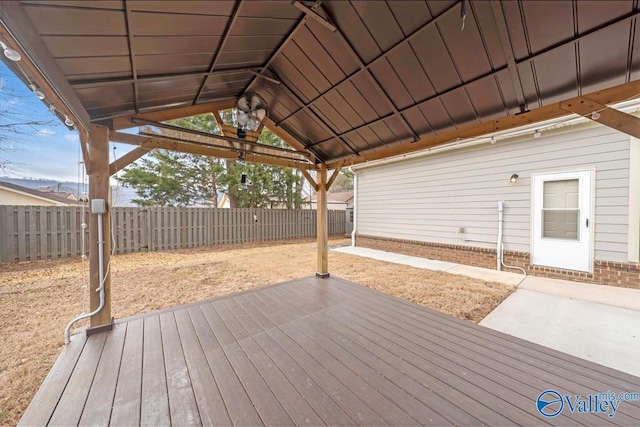 wooden terrace with a fenced backyard, a patio, and a gazebo