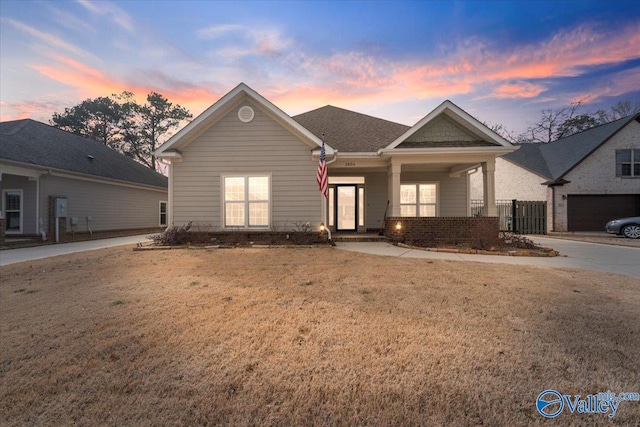 view of front facade with brick siding and a lawn