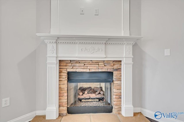 interior details featuring a fireplace and baseboards