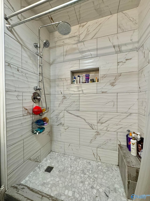 bathroom with a tile shower