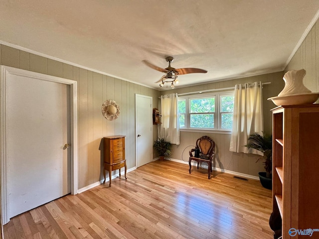 unfurnished room with ceiling fan, light hardwood / wood-style floors, and ornamental molding