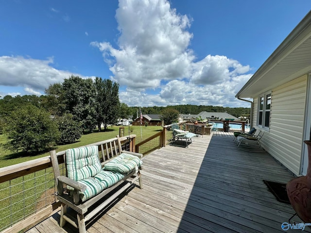 wooden terrace featuring a lawn