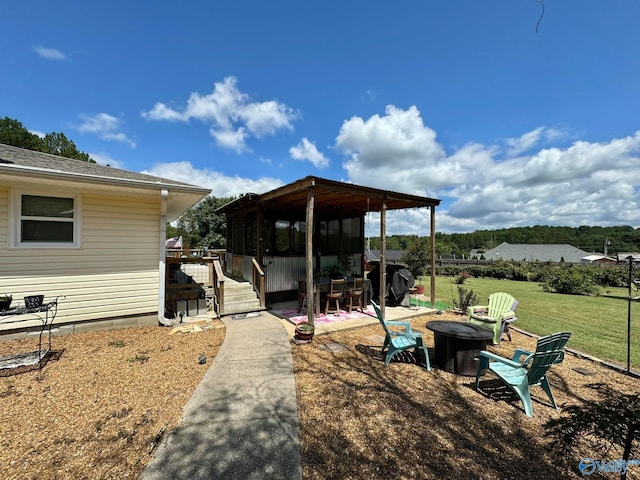 view of yard featuring an outdoor fire pit and a patio