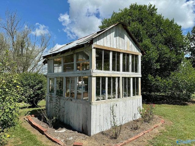 view of outdoor structure with a sunroom