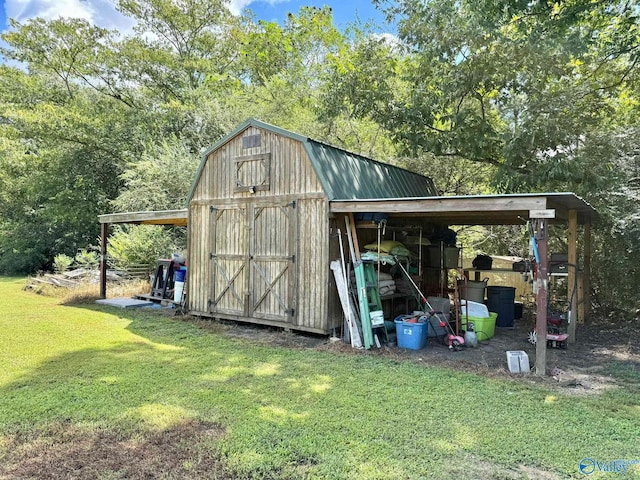 view of outbuilding featuring a yard