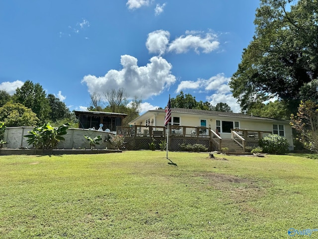 view of yard featuring a sunroom and a wooden deck