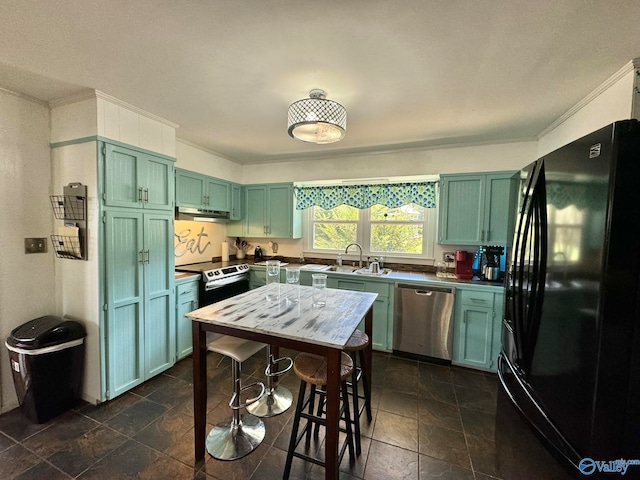 kitchen with sink, stainless steel appliances, dark tile patterned floors, and green cabinets