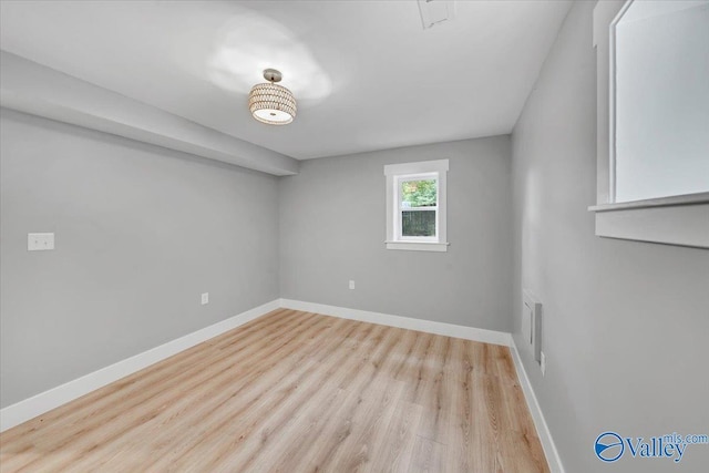 unfurnished room with light wood-style floors and baseboards