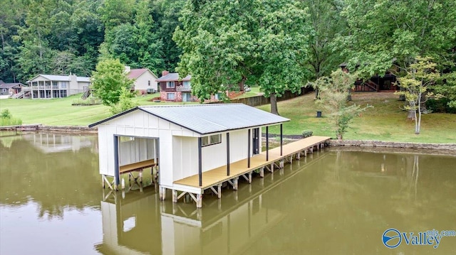 dock area with a water view and a lawn