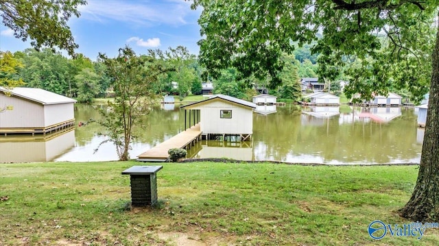 view of front of home with a dock, a water view, and a front yard