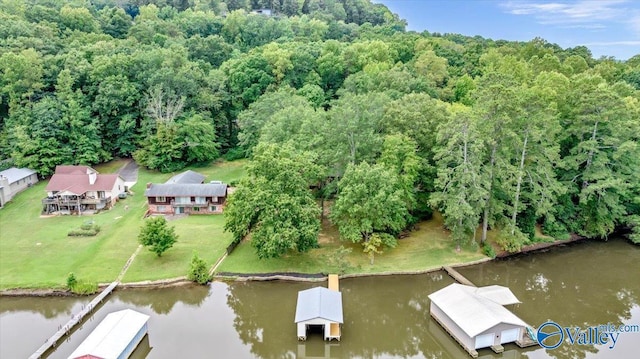 drone / aerial view featuring a water view and a forest view