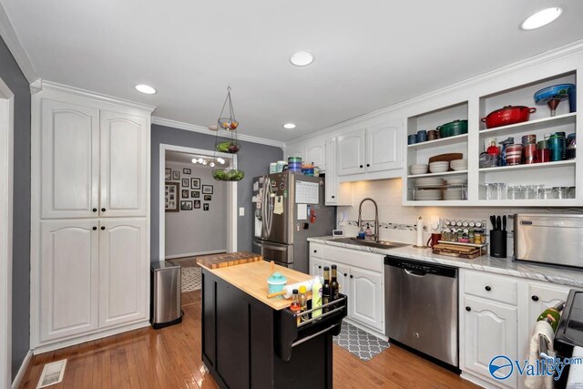 4315 Horace Dr NW, Huntsville, AL 35816 - kitchen with white cabinetry, stainless steel appliances, and light wood-type flooring