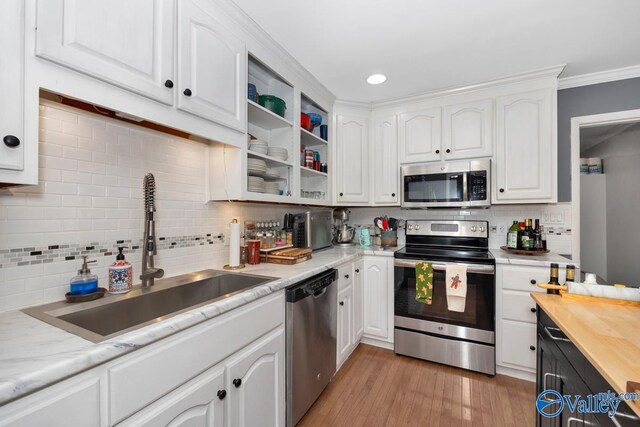4315 Horace Dr NW, Huntsville, AL 35816 - kitchen featuring sink, stainless steel appliances, crown molding, white cabinets, and light wood-type flooring