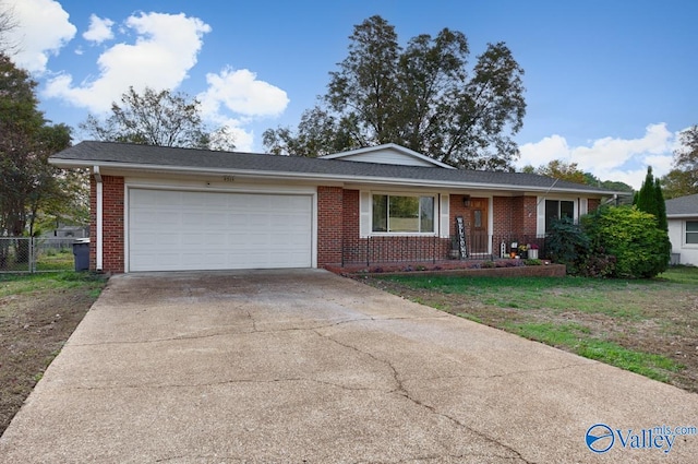 single story home with a porch, a garage, and a front lawn