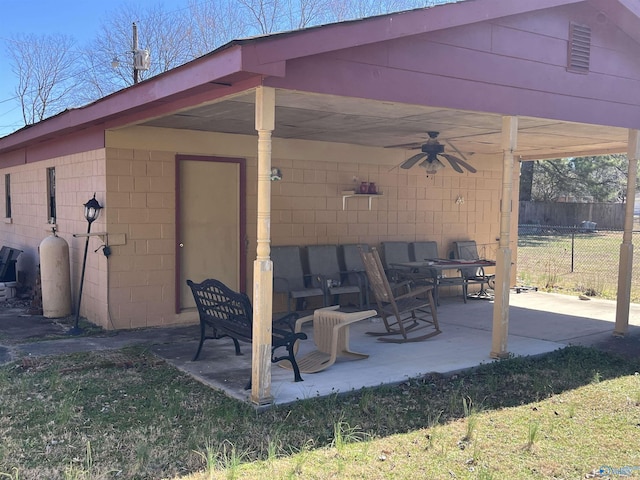 view of patio / terrace featuring a ceiling fan and fence