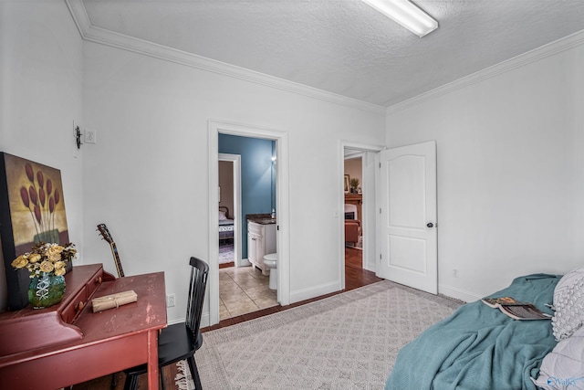 1635 County Road 47, Fyffe, AL 35971 - bedroom with ornamental molding, a textured ceiling, baseboards, ensuite bath, and an office area
