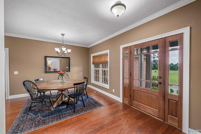 1635 County Road 47, Fyffe, AL 35971 - dining area featuring a textured ceiling, wood finished floors, a chandelier, baseboards, and ornamental molding
