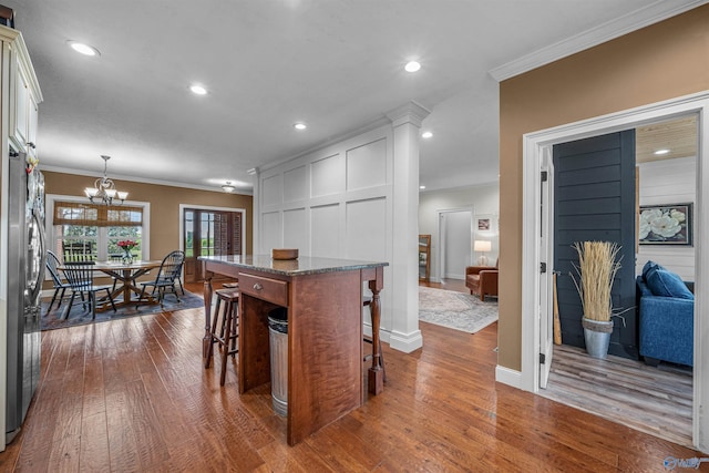 1635 County Road 47, Fyffe, AL 35971 - kitchen with freestanding refrigerator, dark wood-type flooring, a kitchen bar, crown molding, and a chandelier