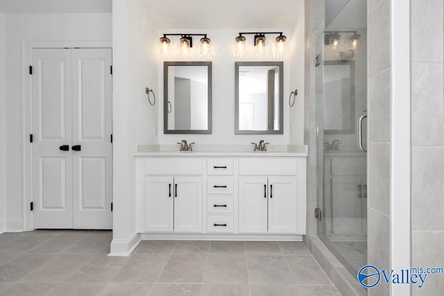 bathroom with vanity, tile patterned floors, and a shower with door