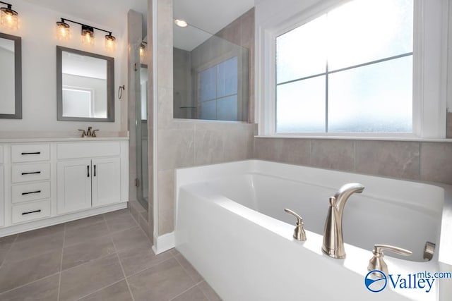 bathroom featuring vanity, tile patterned floors, and shower with separate bathtub