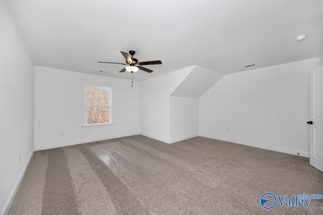 additional living space with vaulted ceiling, ceiling fan, and carpet