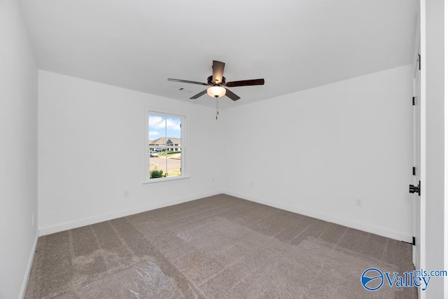 carpeted spare room featuring ceiling fan