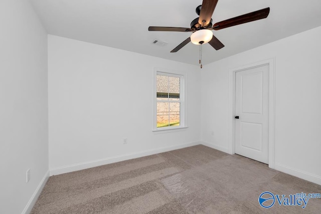 carpeted spare room with ceiling fan