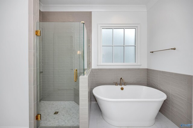 bathroom featuring independent shower and bath and tile walls