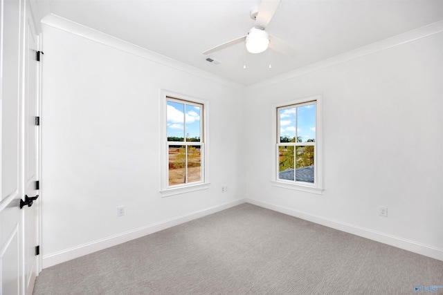 unfurnished room featuring light carpet, ceiling fan, and ornamental molding