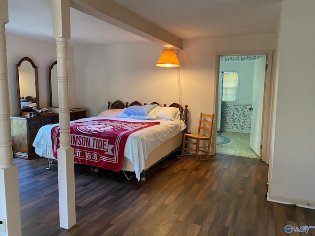 bedroom featuring wood finished floors and decorative columns
