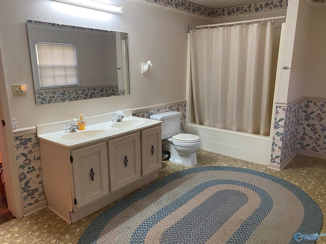 full bathroom with double vanity, shower / bathtub combination with curtain, toilet, and a sink