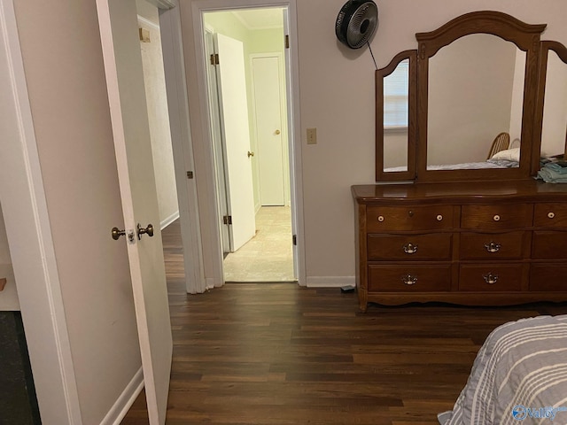 bedroom featuring dark wood-style flooring and baseboards