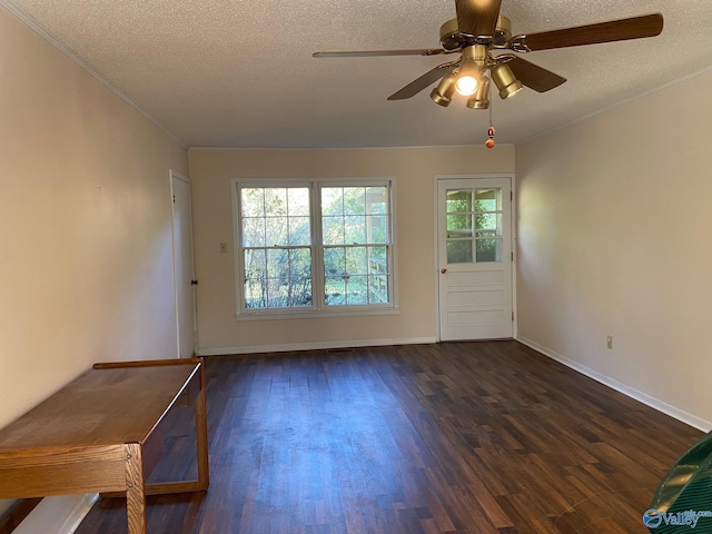 doorway featuring ornamental molding, dark wood-style floors, a textured ceiling, and a ceiling fan