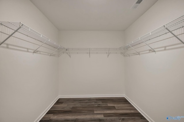 walk in closet featuring dark wood-style floors and visible vents