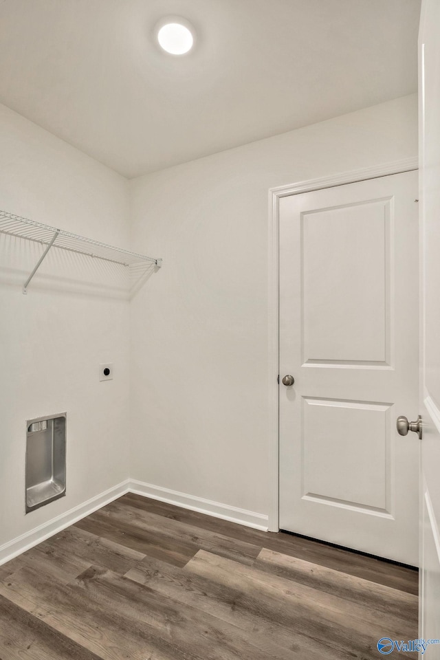 washroom featuring laundry area, baseboards, dark wood-type flooring, and hookup for an electric dryer