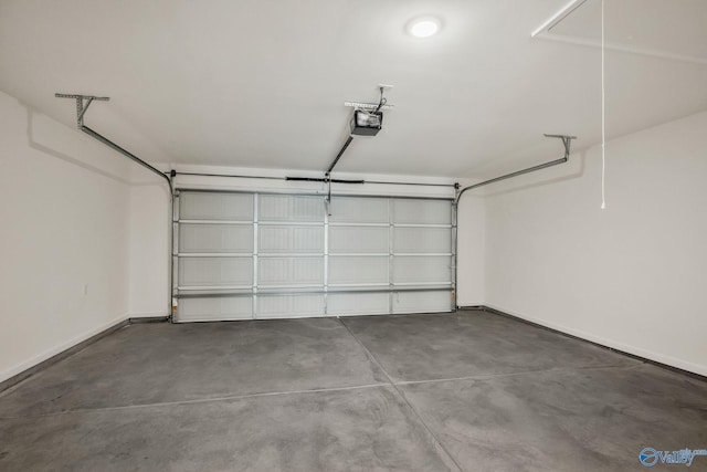 garage featuring a garage door opener and baseboards