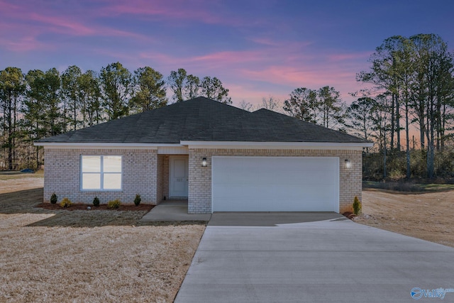 single story home featuring brick siding, concrete driveway, and a garage